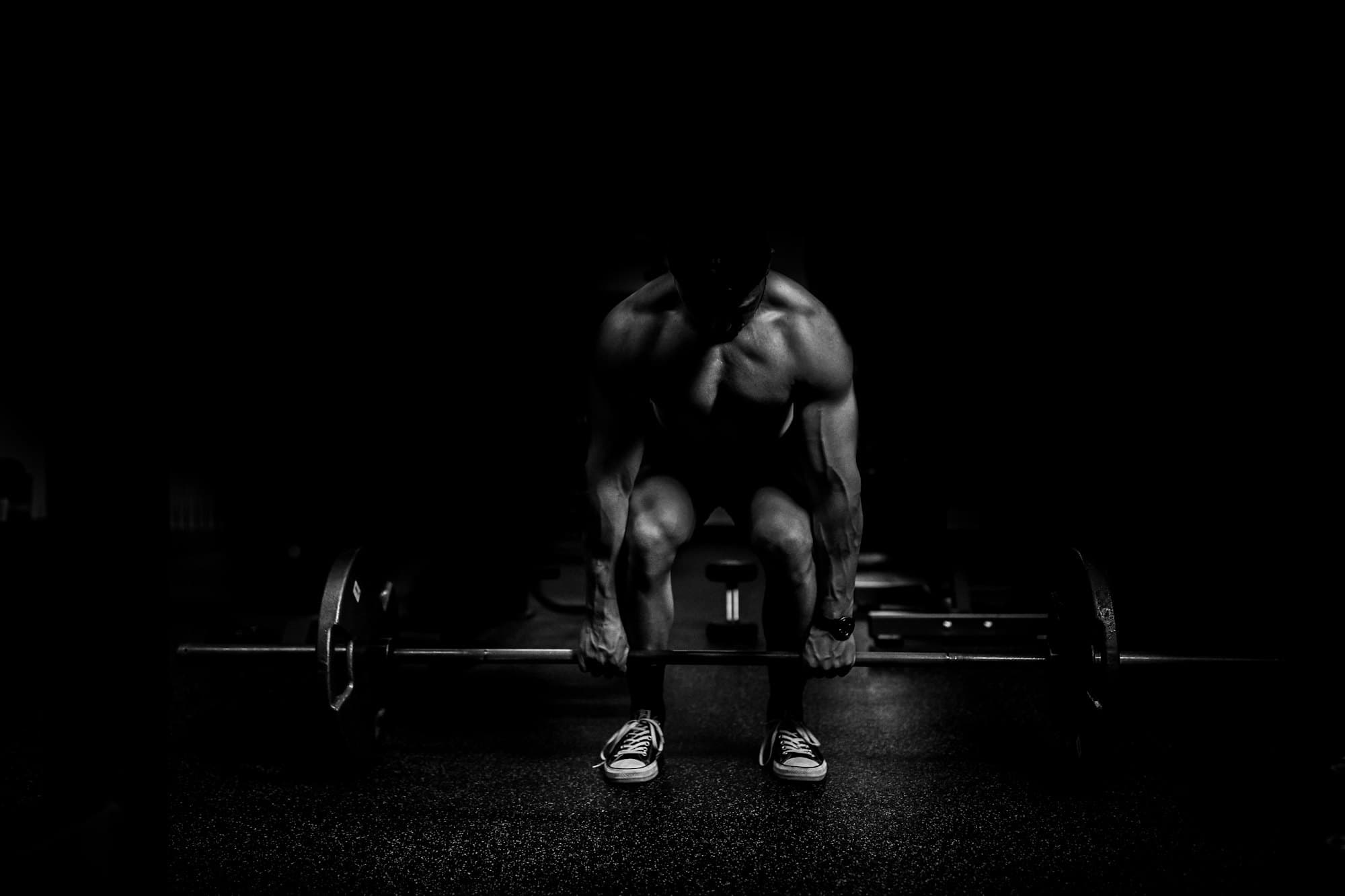 Lifter setting up under a loaded barbell