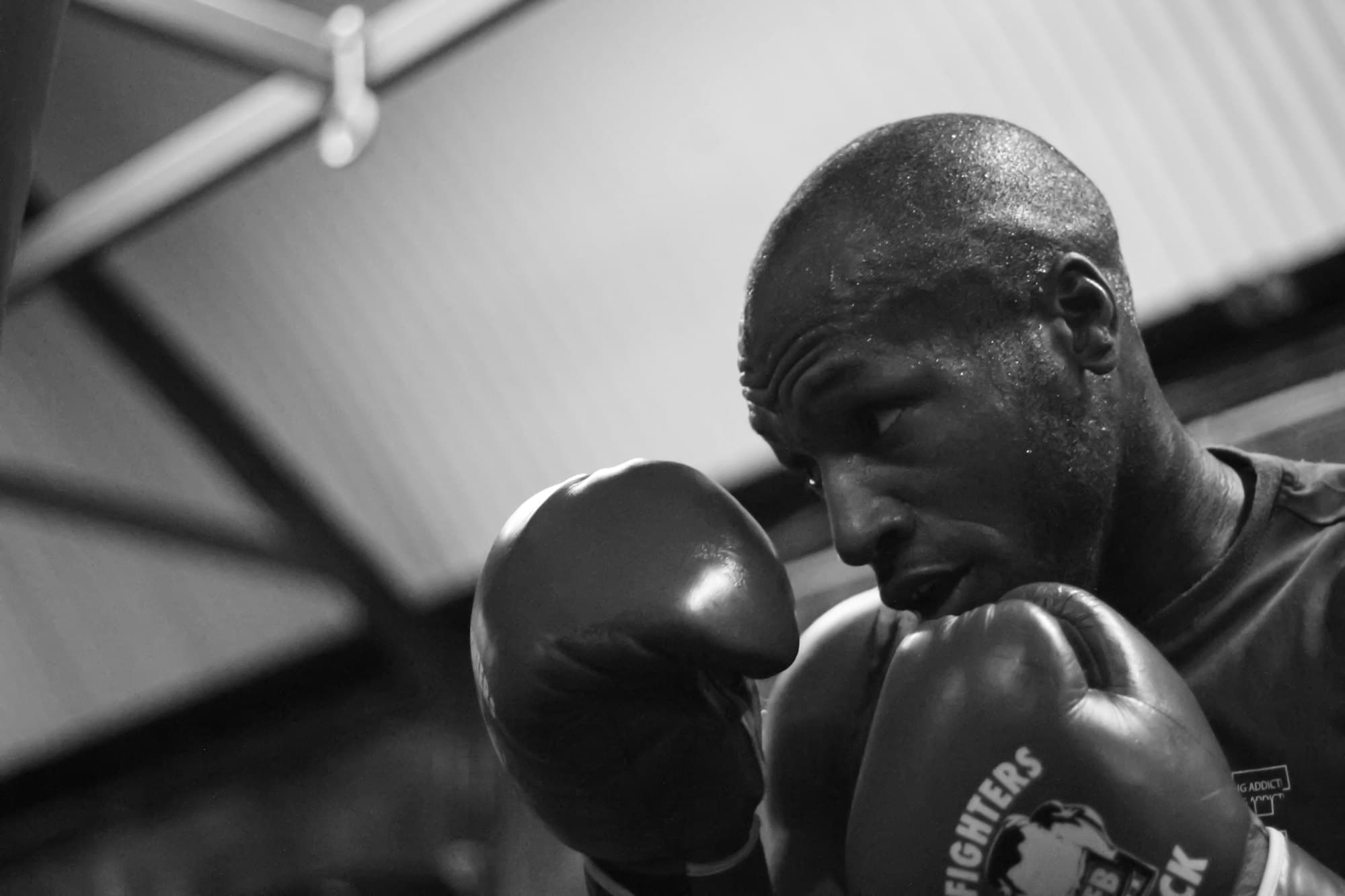 Boxing gloves hanging in a dark gym