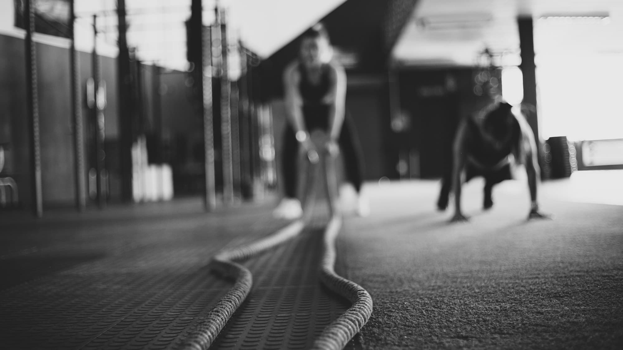 Two members working out together on the gym floor
